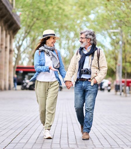 Man and woman holding hands while walking